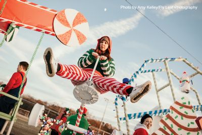 Woman in Christmas outfit on seesaw at Christmas event