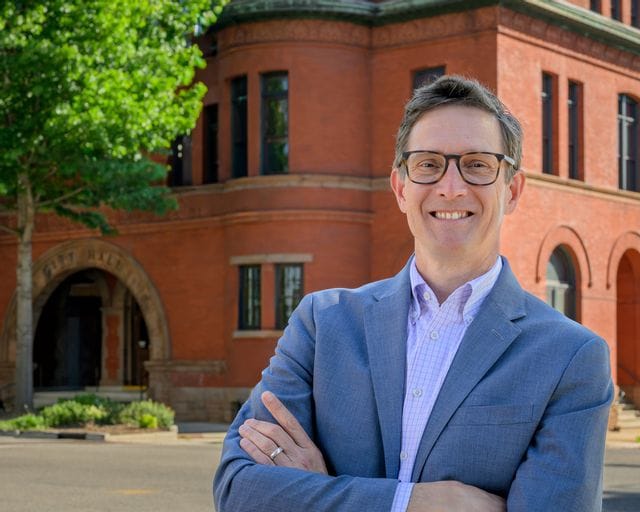 Image of Ron Smith, City Manager for the City of Statesville. Ron is standing in front of Statesville City Hall.
