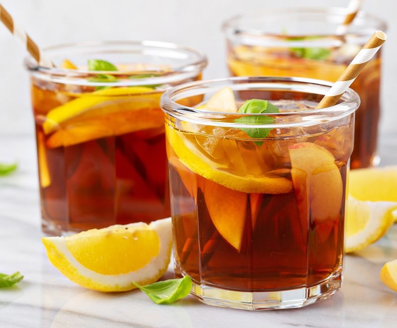 Glass of Sweet Tea with lemon wedges and sprigs of mint