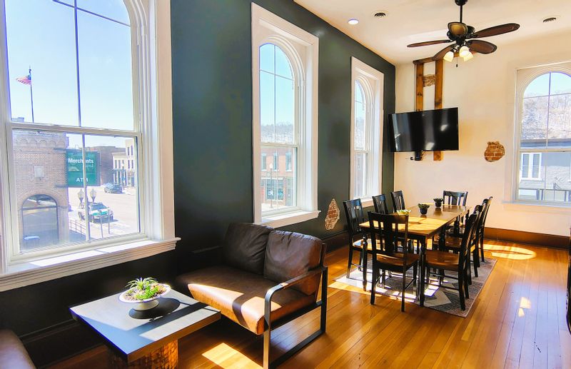 Meeting Room with table seating for 8 people in a bright room facing downtown Lanesboro