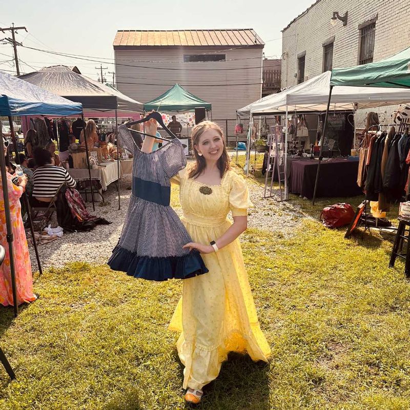 Model holding vintage clothing at Far Out Fashion Show