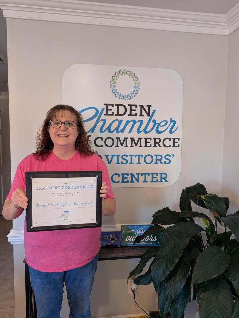 Christi Wenger holding her Energize Eden Grant Award at the Eden Chamber of Commerce