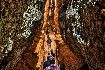 People walking through a cave corridor while on a tour of Niagara Cave near Lanesboro, MN