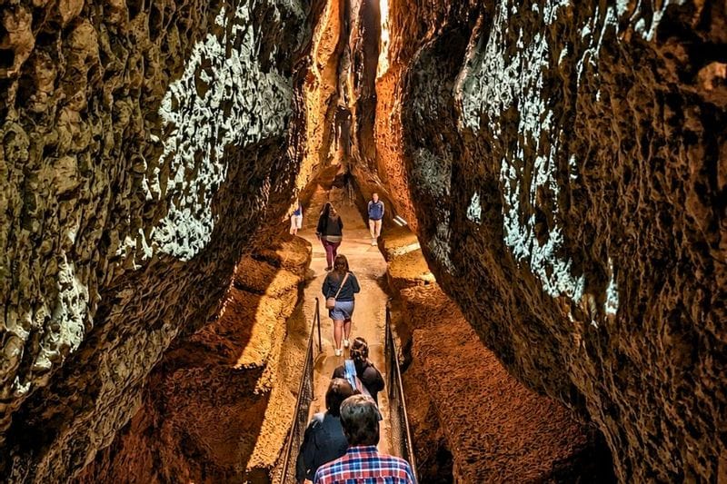 People walking through a cave corridor while on a tour of Niagara Cave near Lanesboro, MN