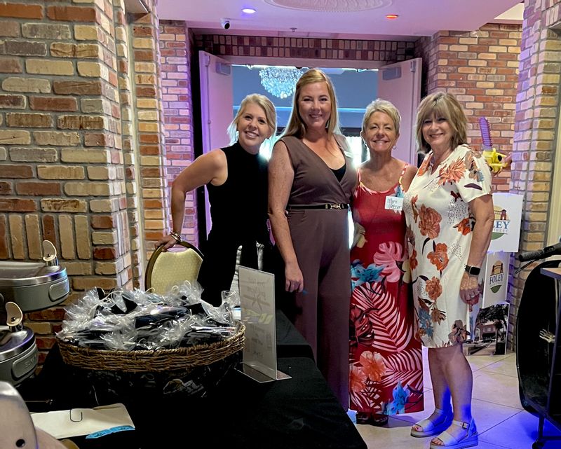 Set up crew for the Foley Main Street October meeting . L to R:  Lindsay Schumacher, L. Schumacher Consulting; Lilian Taylor, Lillian Taylor Consulting; Marti Webster, Foley Brunch & Supper Club; and Connie Robertson, Promotions committee. 