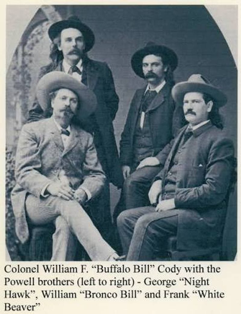Black-and-white historical portrait of four late-19th-century men wearing wide-brimmed hats and suits, posed together with mustaches and period clothing against a studio backdrop.