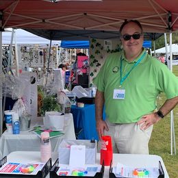 Board Member Todd Koniar mans the booth at the BBQ & Blues event 2020
