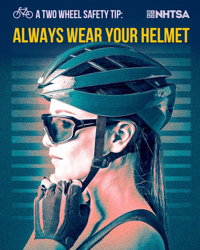A person wearing a bicycle helmet and sunglasses is shown in profile, adjusting the helmet strap under their chin. The image includes bold text that reads, “A Two Wheel Safety Tip: Always Wear Your Helmet,” along with the NHTSA (National Highway Traffic Safety Administration) logo. The background features a stylized blue and teal design, emphasizing the importance of helmet use for bicycle safety.