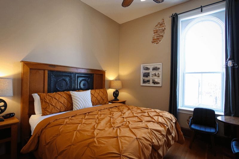 Iron Horse King Room at Root River Inn with cozy bedding, historic details, and natural light.