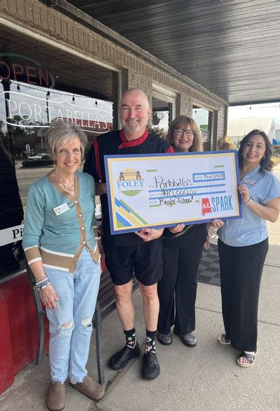 Rich and Pam Lee received their $10,000 check for their winning Pitch video in the ALSPARK Bright Ideas contest. They now advance to regionals for a chance to win another $10,000. Also pictured are Foley Main Street board members Deborah Mixon and Sabrina May.