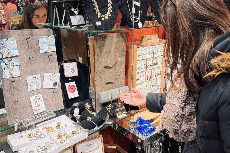A woman checks out a jewelry display while shopping at E2 Boutique in Lanesboro, MN
