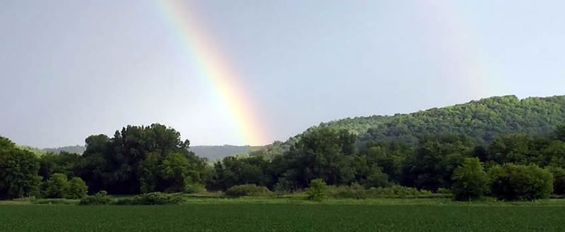 A rainbow over the bluffs of Rushford Village, MN