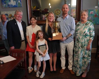 Mayor Doug Hendrix, Abigail Walker, Anna Walker, Kelli Simko, John Walker,  and CAC Chair Sherry Harris (Pictured from left) pose together while Mayor Hendrix presents the 2025 Mayor’s Cup Award trophy and plaque.