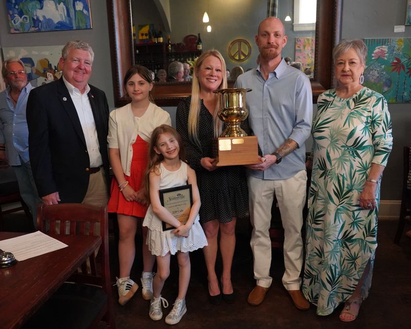 Mayor Doug Hendrix, Abigail Walker, Anna Walker, Kelli Simko, John Walker,  and CAC Chair Sherry Harris (Pictured from left) pose together while Mayor Hendrix presents the 2025 Mayor’s Cup Award trophy and plaque.