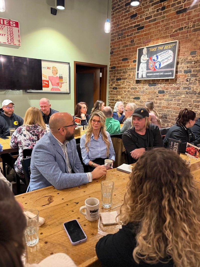  People talking at Puckett's Restaurant for Main Street's Biscuits and Business gathering