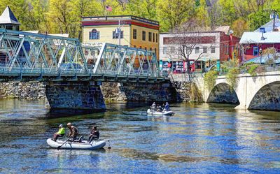 Fishing boats on Deerfield River between two bridges