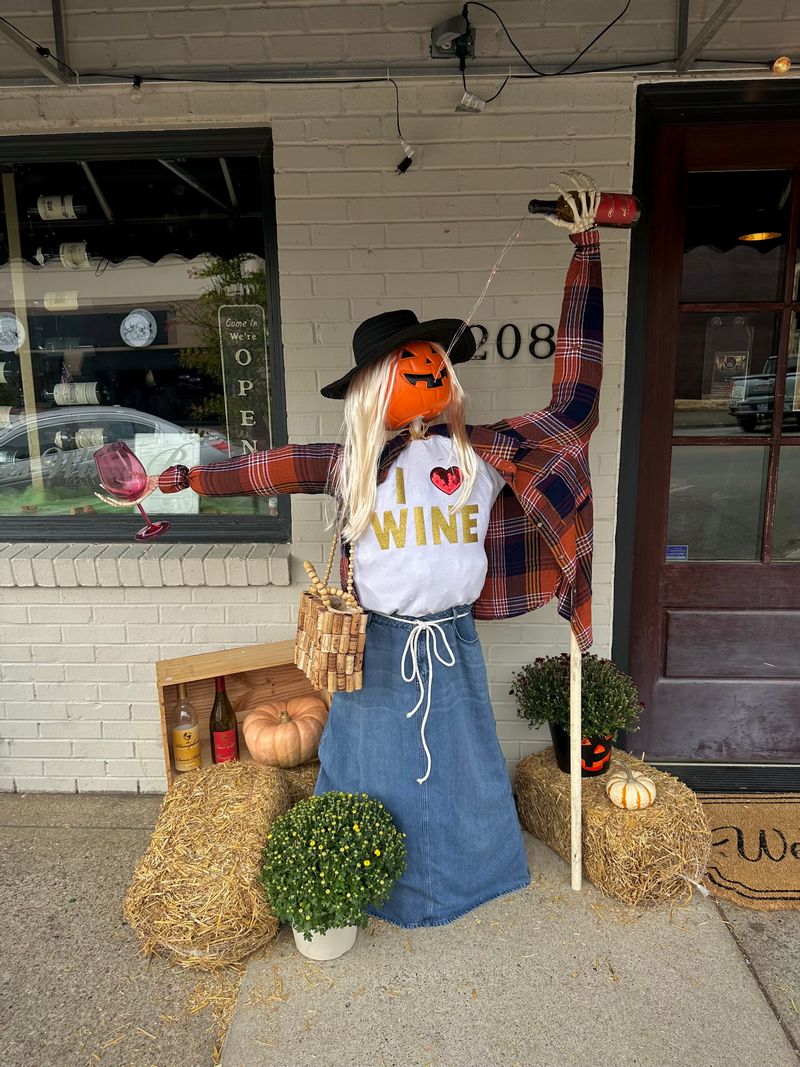 Scarecrow lady drinking wine