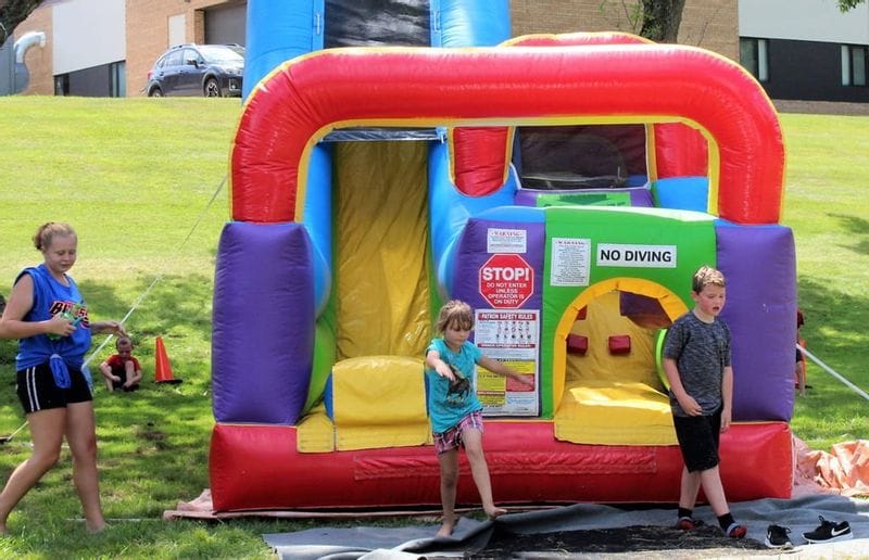 Children playing near a bouncy house in Lanesboro's Sylvan Park during Buffalo Bill Days