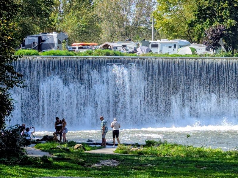 People taking photos in front of the Lanesboro Dam