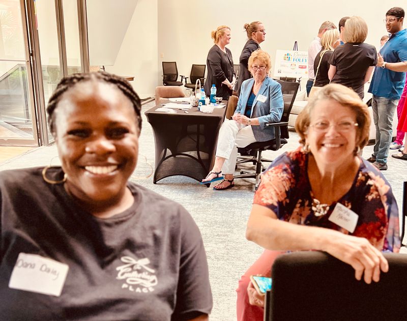 Dana Dailey and Marsha Kaiser waiting for the program to begin while JaNay Dawson looks on 