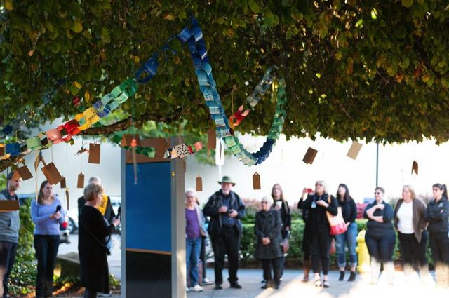 PMG PHOTO: CHRIS OERTELL – Colorful wishing chains made by students at Lincoln Street Elementary School and Glencoe High School hang on a weeping elm tree during the opening ceremony for Hillsboro’s Wishing Tree at the Washington County Courthouse in Hillsboro, on Tuesday, Oct. 1, 2019.