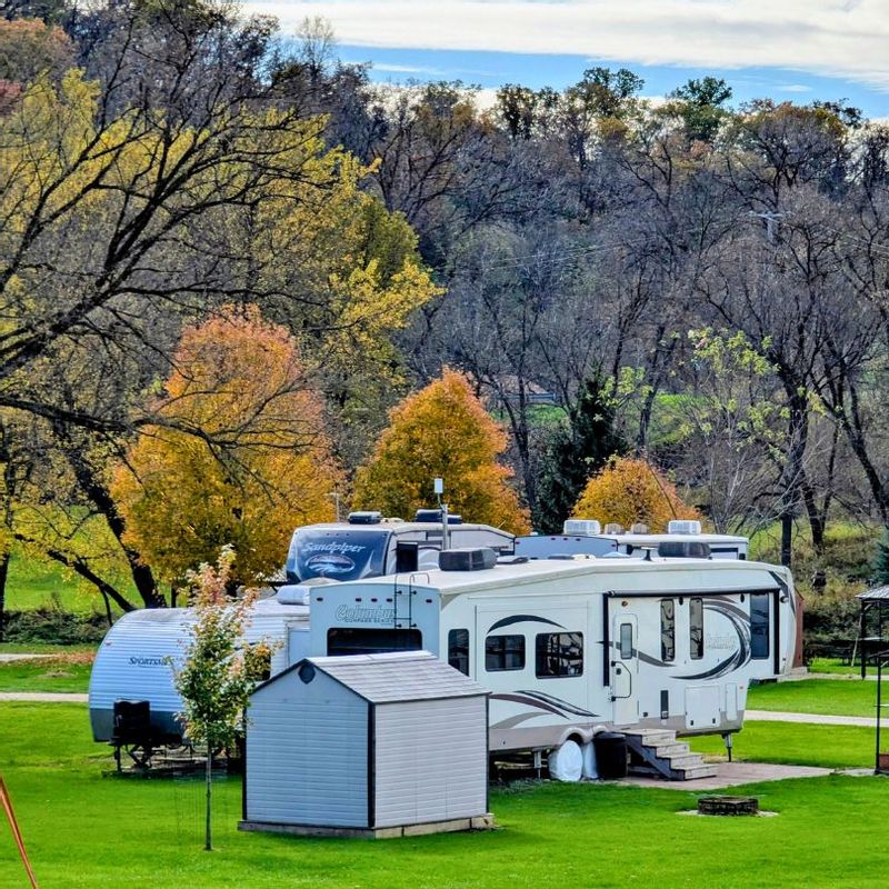 RV and camper sites at a campground in Lanesboro, Minnesota, surrounded by fall colors and tree-covered bluffs in Bluff Country