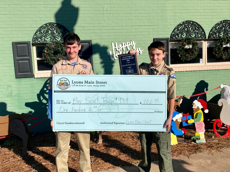 Boy Scout Troop #939 receives a check in the amount of $100 for best walking group.