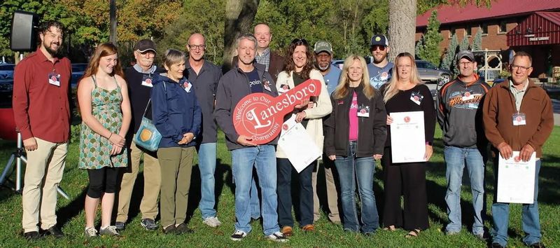 Lanesboro Area Chamber of Commerce members and community participants gather during a Welcoming Week event in Lanesboro, Minnesota.