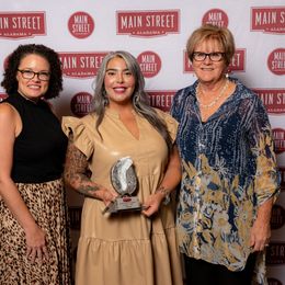 Foley Main Street Board member Kristin Hellmich, Foley Art Center Executive Director Chloe Salinas and Foley Main Street Executive Director Darrelyn Dunmore accepted the Promotion Award of Excellence for the CATalyst event.