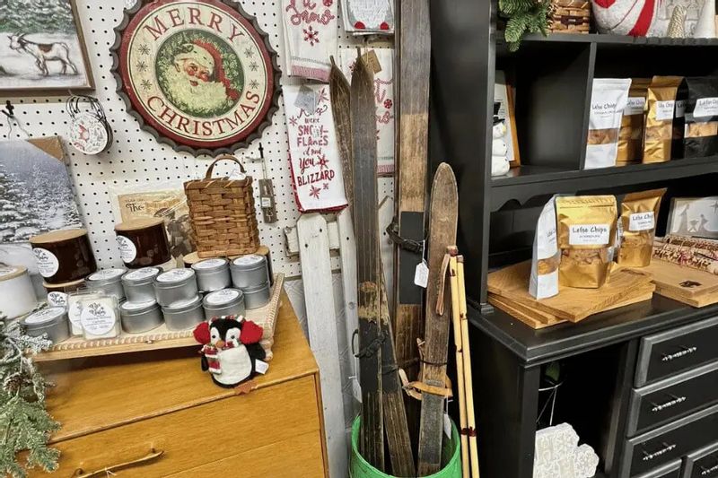 Holiday decor and locally made gifts at Bee Balm Boutique in Harmony, Minnesota, featuring vintage skis, Christmas signs, candles, and specialty foods.