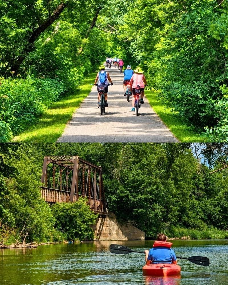 Two photos showing outdoor recreation in Lanesboro, MN. The top photo shows a group of bikers on the Root River State Trail surrounded by lush green forest. The bottom photo shows a person kayaking the Root River near an iron bike trail bridge. 