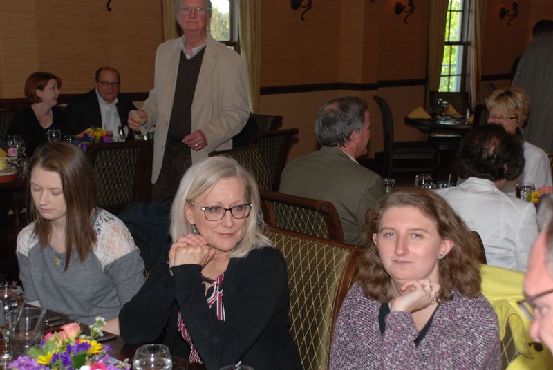 three women sit at table with Exchange Club